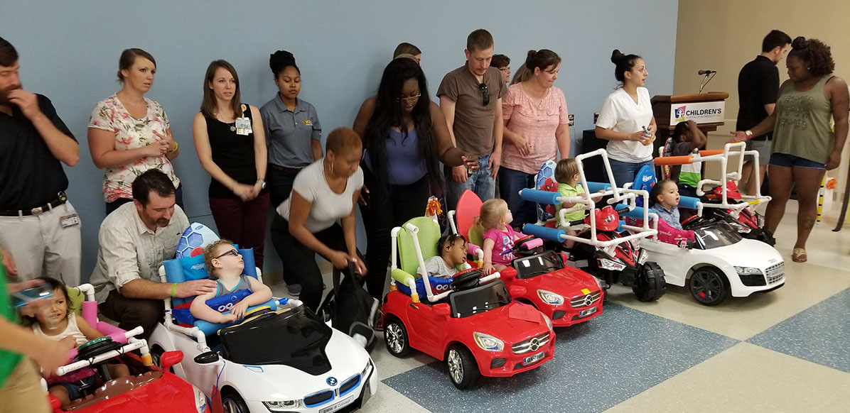 Parents and kids in the lobby of the College of Health Professions.